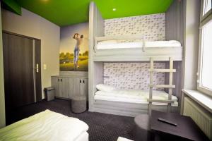 a bedroom with bunk beds with a green ceiling at Olympic - Old Town in Gdańsk