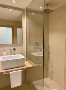 a bathroom with a sink and a mirror at Casa Bodhi Boutique Hotel & Spa in Marbella