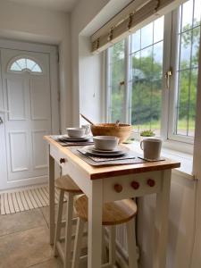 a kitchen with a table with bowls on it at The Old Flour Mill in Broadway