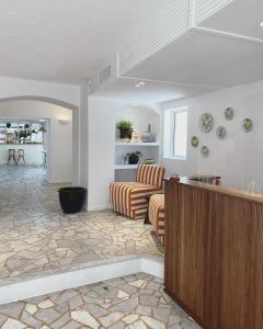 a living room with a couch and a table at Hôtel Le Sud in Juan-les-Pins