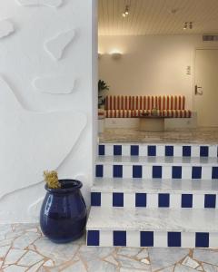 a large blue vase sitting on the floor of a building at Hôtel Le Sud in Juan-les-Pins