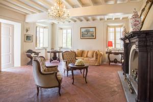 a living room with a couch and a fireplace at Villa Melangola in Camaiore