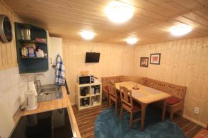 a kitchen and dining room with a table and a sink at Ferienhaus Am Wald in Tambach-Dietharz