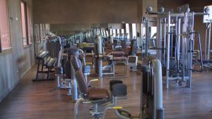 a gym filled with rows of exercise equipment at Oasis Palm Hotel in Guelmim