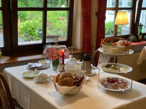 a table with a white table cloth with food on it at Hotel Springiersbacher-Hof in Kröv