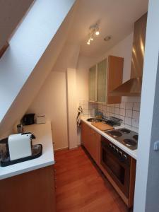 a kitchen with a sink and a stove at Zentrales Dachgeschoss-Apartment Bielefeld in Bielefeld