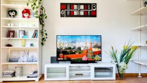 a living room with a flat screen tv on a white entertainment center at Forum-CCIB-Relax Flats in Barcelona
