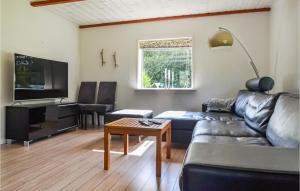 a living room with a couch and a table at Cozy Home In Varde With Wifi in Varde