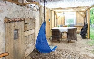 a blue hammock sitting on the side of a house at Nice Apartment In Pelm With Wifi in Pelm