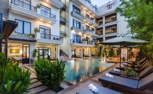 an exterior view of a building with a swimming pool at Bayon Modern Residence in Siem Reap