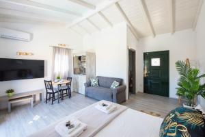 a living room with a couch and a table at Acharavi Beach Villa in Acharavi