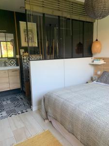 a bedroom with a bed and a glass wall at La cabane 62 in La Teste-de-Buch +17 photos