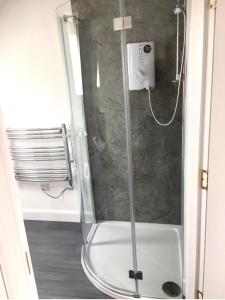 a shower with a glass door in a bathroom at Kilberry Guest House in Beauly