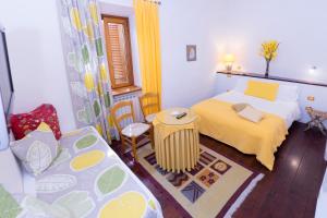 a small bedroom with a bed and a table at La Torretta in Tuscania