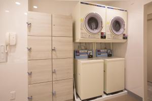 a laundry room with two washer and dryer at Kuretake Inn Nagoya Hisayaodori in Nagoya