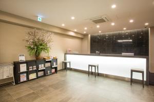 a waiting room with a large whiteboard in a building at Kuretake Inn Nagoya Hisayaodori in Nagoya