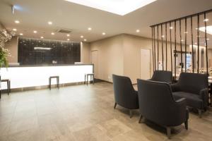 a waiting room with chairs and a white counter at Kuretake Inn Nagoya Hisayaodori in Nagoya
