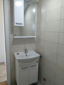 a white bathroom with a sink and a mirror at The Brothers Villa Hotel in Ohrid +41 photos