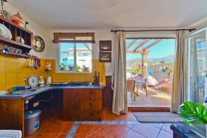 a kitchen with a sink and a sliding door to a patio at Apartamento Yaiza in Nerja