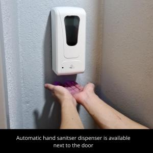 an automatic hand sanitizer dispenser is available next to the door at Cozy Apartment @ Hospital Sungai Buloh in Sungai Buluh