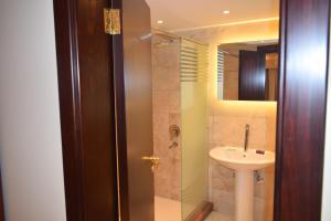 a bathroom with a sink and a shower at Omar El Khayam Al Minya Hotel - Luxury Accommodation in Minya