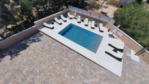 an overhead view of a swimming pool on a patio at Poolside Hideout Apartments in Novalja