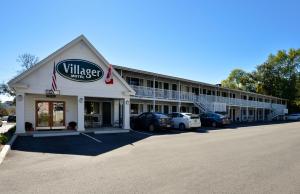 a large white building with a sign on the side of it at Bar Harbor Villager Motel - Downtown in Bar Harbor