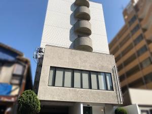 a tall building with windows on the side of it at THE HOTELS HAKATA KASANE Bayside in Fukuoka