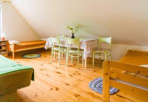 a dining room with a table and chairs in a attic at Wigierska Zagroda - agroturystyka in Suwałki