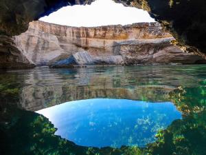 a view of the water from inside a cave at Villetta Carati in Torre dell'Orso