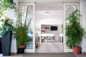 an open door to a living room with potted plants at HOTEL GIAMAICA in Cattolica