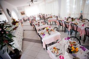 a dining room with tables and chairs with flowers on them at HOTEL GIAMAICA in Cattolica +4 photos