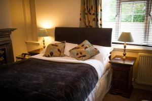 A bed or beds in a room at Claverton Hotel 