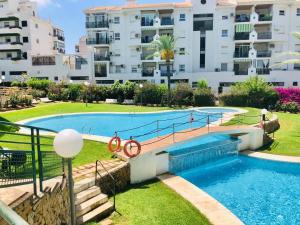 a swimming pool in a apartment with a building at Apartment Beach El Albir in Albir