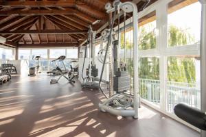 a gym with treadmills and machines in a room with windows at La Cala de Mijas Getaway in Sitio de Calahonda