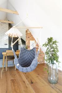 a blue hammock in a living room with a table at Green Deer Premium in Zakopane