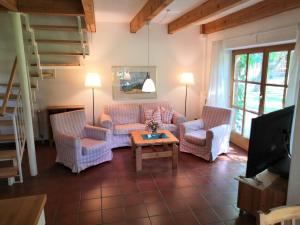 a living room with two couches and a coffee table at Ferienhof Trapp in Ellringen