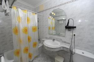 a bathroom with a sink and a shower curtain at Hostal O Portiño in Rianjo