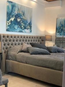 Apartment New Luxury Prince-Suite Venezia San Marco في البندقية: سرير كبير في غرفة نوم مع لوحة على الحائط