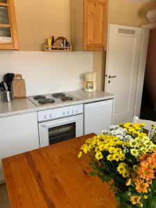 eine Küche mit einem Tisch und einer Vase aus Blumen in der Unterkunft Ferienwohnung Frühlingsau in Freudenstadt