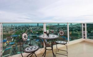 a balcony with a table and two chairs at Rare Panoramic Sea, City & Mountain Views - XXL Balcony - Free Fast WIFI - Pool - City Garden Tower 2317 in Pattaya South