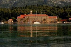 a large building in the middle of a body of water at Guest House Dijana in Korčula