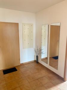 a room with three mirrors on the wall at Steigerwaldblick Apartments Burgebrach in Burgebrach