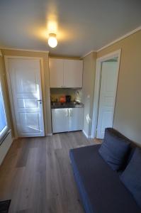 a living room with a couch and a kitchen at Hovstø in Seljord