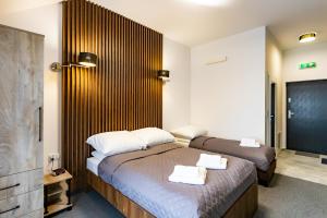 a bedroom with two beds with towels on them at Willa Zdrojowa in Polańczyk