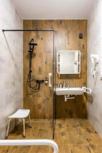 a bathroom with a shower and a sink at Willa Zdrojowa in Polańczyk