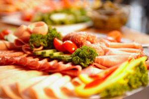 a plate of food with vegetables on a table at Hotel Leipzig City Nord by Campanile in Leipzig