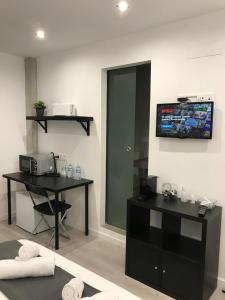 a room with two desks and a television on the wall at Casa Cumbre del Sol in Benitachell