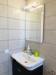 a bathroom with a white sink and a mirror at Las Vistas Beach in Playa de las Americas