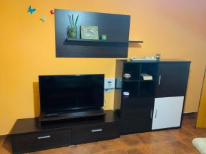 a entertainment center with a flat screen tv in a room at Casa A Confianza in Isla de Arosa